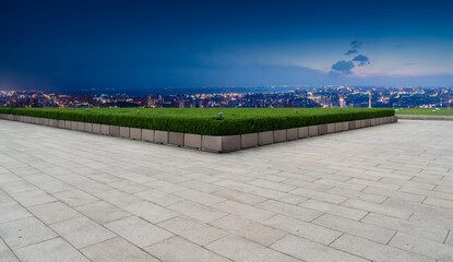 Empty brick floor with city skyline background