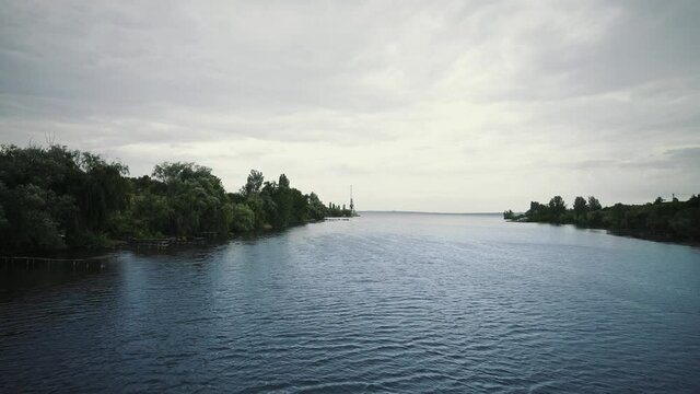 Panorama of morning lake. Landscape with water and trees. Pattern on water surface. Ripple in water.