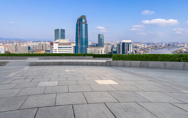 Empty brick floor with city skyline background