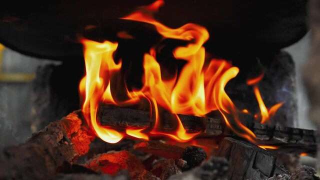 Real wood logs. Fireplace. Camping. Keeping warm. Tongues of flame engulfed the log. Burning Fire. 