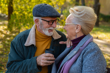 Senior couple sitting and drinking hot coffee.