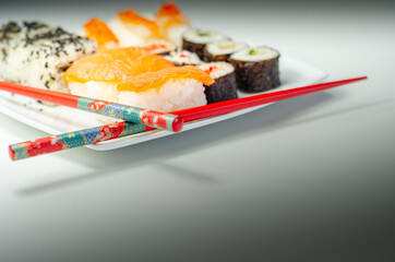 Set of smoked salmon nigiri, Ebi king prawn nigiri, sweet chilli pawn and red pepper California roll, cucumber with wasabi hosomaki roll and red pepper hosomaki roll