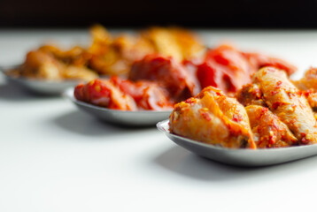 Three different set of the chicken wings with sriracha glaze, Caribbean marinade and Chinese glaze