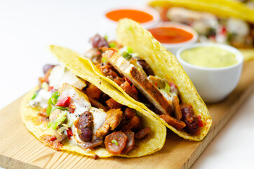 Mexican tacos shells with chicken and red kidney beans, onion,  red and green peppers, and salsa sauce