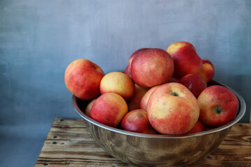 Many apples are in a large bowl