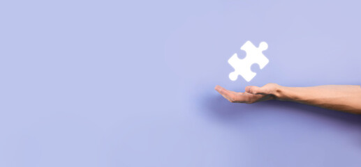 Businessman hands connecting puzzle pieces representing the merging of two companies or joint venture, partnership, Mergers and acquisition concept.