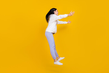 Fototapeta na wymiar Full body profile side photo of excited lady jump hug empty space meet best friend isolated over bright yellow color background