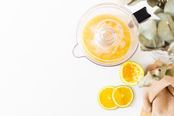 Raw oranges, and juicer on white background. Fresh healthy fruits, concept.