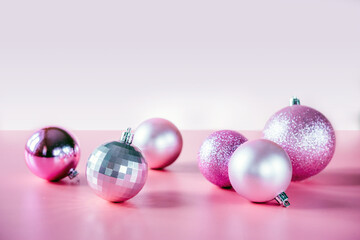 Pink Christmas tree balls on pink background, Christmas and New Year holiday composition