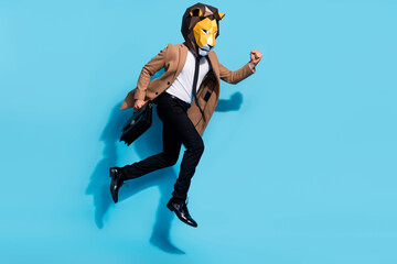 Full length photo of bizarre incognito guy lion mask jump up hold hand bag hurry partners briefing...
