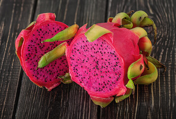 Two halves of dragon fruit on planks