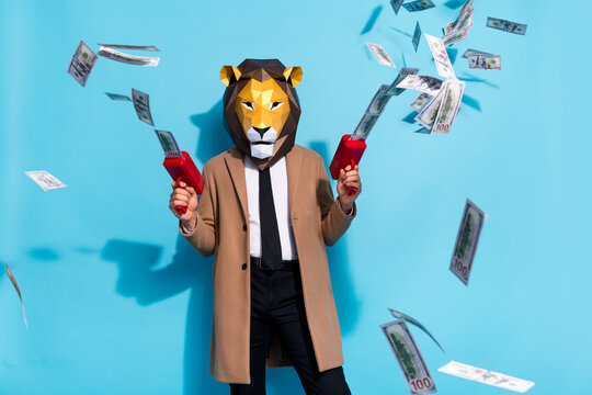 Photo of weird anonym guy lion mask shoot pistol earnings profit money freak crazy character isolated over blue color background