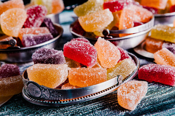 Dessert marmalade in the form of lemon and orange slices. The sweetness of jelly candy.