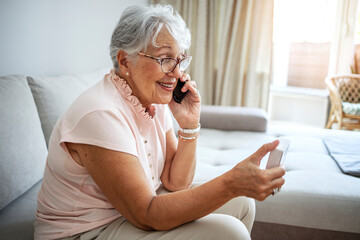 Elderly woman checking medical information while using mobile phone. Senior woman talking on...