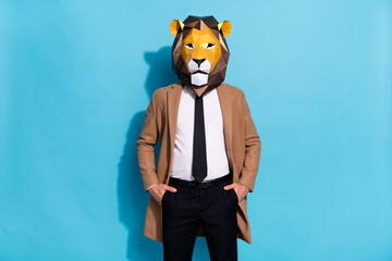 Photo of successful freak lion mask guy put hands pockets trousers isolated over blue color...