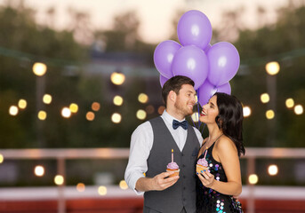 celebration, anniversary and holidays concept - happy couple with ultra violet balloons and...