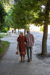 A couple of elderly people walking down the street in Drohobych. Ukraine 