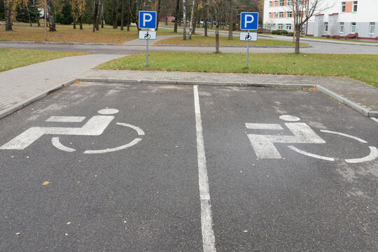 Photo of signs on the asphalt for parking for cars for disabled people in the city