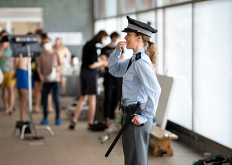 Fototapeta na wymiar female police officer in uniform on duty during a public event
