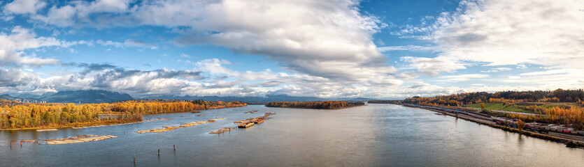 View of Fraser River and Mountain Landscape in background. Sunny Cloudy Fall Season. Aerial Scene from Port Mann Bridge in Coquitlam, Vancouver, British Columbia, Canada. Panoramic View