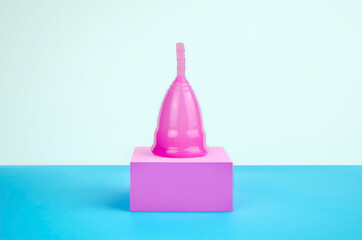 Reusable eco-friendly menstrual cup on the podium. There is a menstrual cup on the pedestal. Alternative menstrual cycle, female healthcare concept