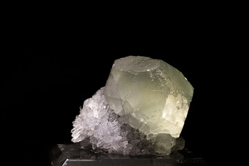 isolated fluorite crystal mineral above quartz in black background