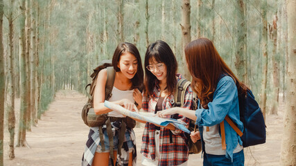 Asian hiker women trekking in forest. Young happy backpack girls walking enjoy her journey, travel nature and adventure trip, climb mountain lot of tree in fall holidays vacation concept.