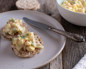 Fitness meal with low fat egg salad and vegetables served with gluten free brown rice cracker