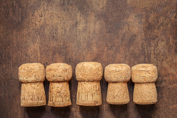 Wine corks closeup on a wooden table. Five wine corks in a row with copyspace. Top view. Flat lay.