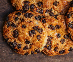 Chocolate cookies with crumbs on dark wooden background. Brown Chocolate chip cookies top view.