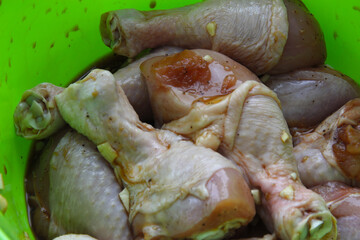 Marinating raw chicken legs. Marinated chicken with garlic 