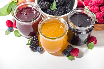 Assortment of berries and fruits jams in jars