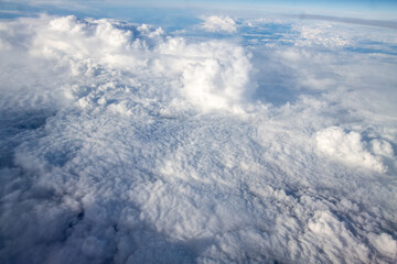Aerial view from airplane during international flight. Travel in airplane, landscape from above and clouds.
