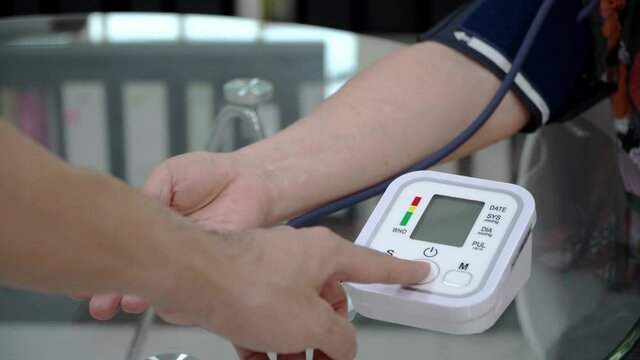 Doctor checking old female patient arterial blood pressure. Health care.Monitoring blood pressure of patients using upper arm blood pressure monitor in the