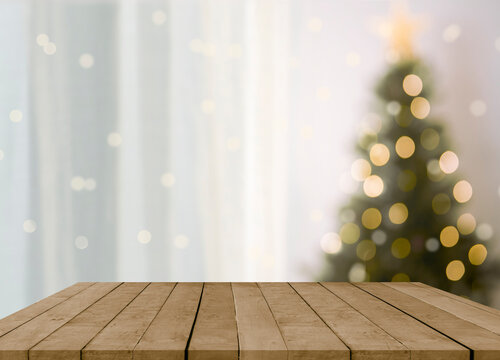 empty christmas table background with christmas tree out of focus for product display montage.