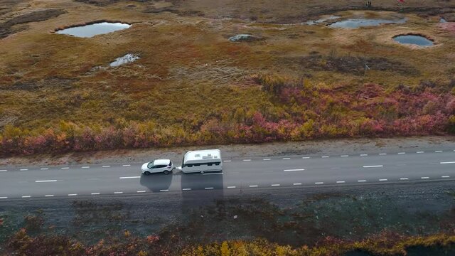 50fps drone footgage Car Camping Caravan driving road lake Swedish Lapland Sunny fall colors Abisko National Park Sweden