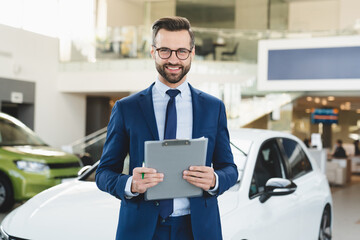 Closeup shot of successful confident smiling caucasian male shop assistant holding clipboard in...