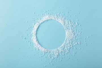 Salt is scattered on a blue background.