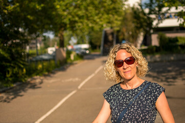 blond woman with sunglasses on the road