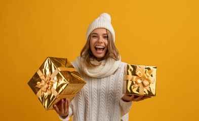 young smiling happy pretty woman holding golden present boxes celebrating new year, christmas...