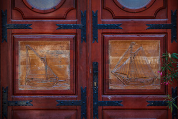 Old doors with wood carved ships in Croatia