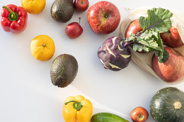 Fresh organic fruits and vegetables on white background.