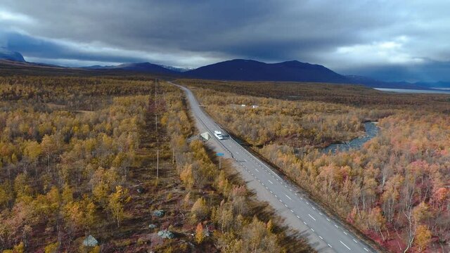 50fps drone footgage Car Camping Caravan driving road lake Swedish Lapland Sunny fall colors Abisko National Park Sweden
