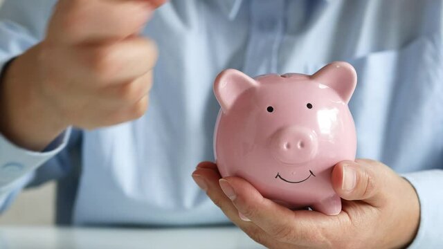 savings and finance concept. woman putting money coin in piggy bank for saving money and plan finance.