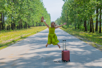 girl in a hat jumping on the road