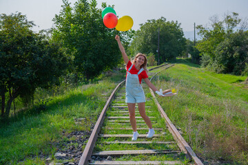 one girl with balls on the railroad goes