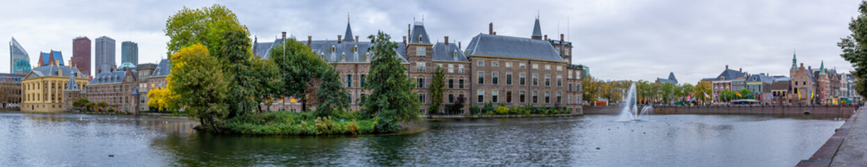 Fototapeta na wymiar Panorama image of the Hofvijver in The Hague during the blue hour with behind the Parliament buildings and the Mauritshuis, the skyline of The Hague
