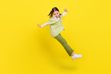 Fototapeta na wymiar Full length body size view of attractive foolish cheery girl jumping having fun fooling isolated on bright yellow color background