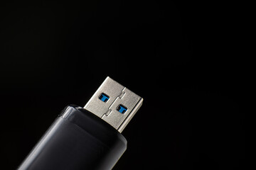 Flash drive close-up on a black background. Data safety concept.