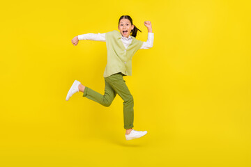 Fototapeta na wymiar Full length body size view of attractive crazy cheerful girl jumping running active isolated on vivid yellow color background